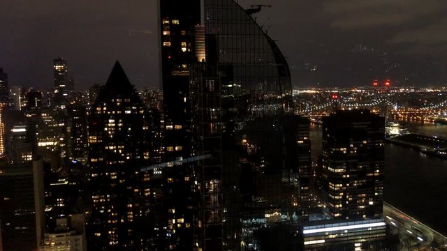 New York skyscrapers in Midtown Manhattan with view on Upper East Side and Queensboro Bridge at night in New York City, USA