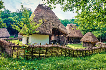 Spectacular summer view of traditional romanian peasant houses. Amazing rural scene of...