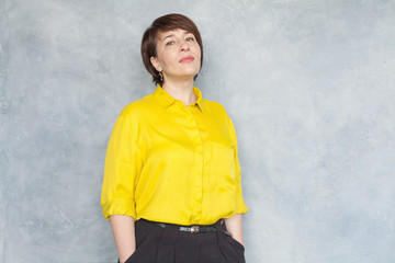 Portrait of confident business woman on gray background