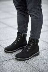 standing man legs in black suede plain boots
