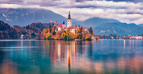 Panoramic morning view of Pilgrimage Church of the Assumption of Maria. Dramatic autumn scene of Bled lake, Julian Alps, Slovenia, Europe. Traveling concept background.