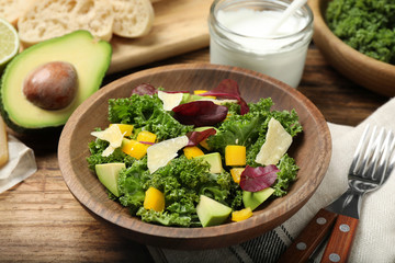 Delicious kale salad served on wooden table