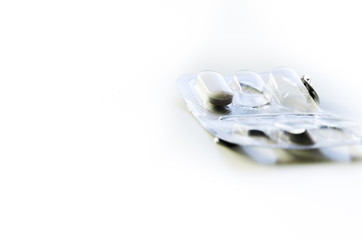 Empty pill box. White pill in plastic cap and aluminum foil from the opposite side. Pharmaceutical...
