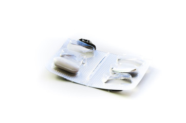 Empty pill box. White pill in plastic cap and aluminum foil from the opposite side. Pharmaceutical...