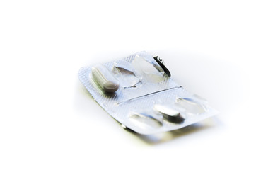 Empty pill box. White pill in plastic cap and aluminum foil from the opposite side. Pharmaceutical drugs for sick people. Research and development of human immunity. Healthy lifestyle