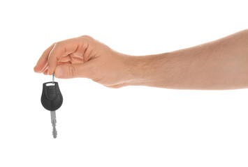 Man holding key on white background, closeup. Car buying