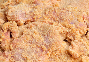 Detail of bread crumbs on cutlet - typical Czech coated meat in breadcrumbs, flour and egg before frying in oil