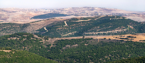 panorama of the israel lebanon border from adir mountain viewpoint showing the stark contrast in...