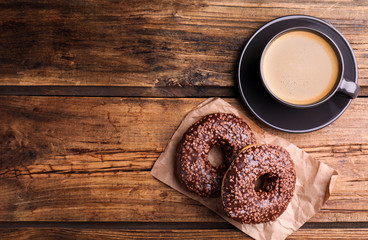 Delicious pastries and coffee on wooden table, flat lay. Space for text