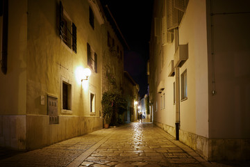 Fototapeta na wymiar Alley in the historical old town of Porec in Croatia in the late evening