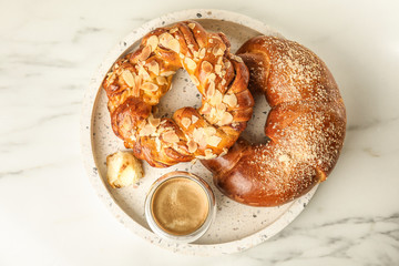 Fresh tasty pastries and coffee on white marble table, top view