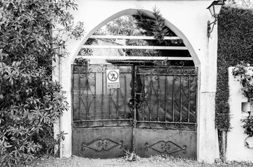 Gate entrance old iron door to land in house in Spain. Typical wooden door design in Andalucia, blac and white