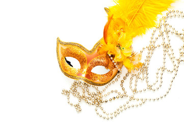Golden Carnival mask on white background with silver beads. Mardi Gras concept. Copy space