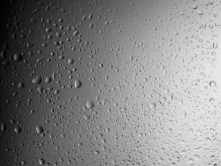 water drops on glass background.Water drops on glass on black background.