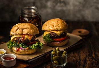 Delicious fresh homemade beef hamburger with pickles and cola beverage