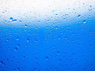water drops on glass background.blue background and droplets.