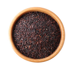 Brown rice in wooden bowl isolated on white, top view