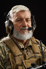 Military veteran with ear defenders.