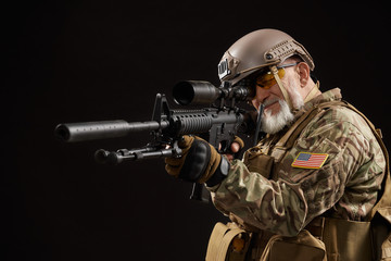 Old military officer pointing with sniper rifle.