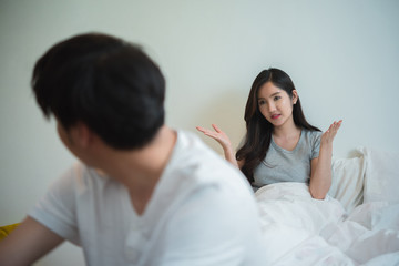 couple young lovers quarreling because of disagreements , on the bed