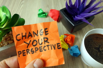 Slogan change your perspective handwritten on sticky note