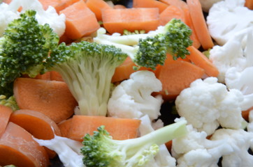 sliced raw broccoli, carrots and cauliflower, beautiful and healthy vegetables, raw and chopped, vegan and vegetarian food, vitamins and minerals, colorful food