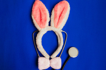 the white rim on the head,Bunny ears ,a stethoscope on blue background