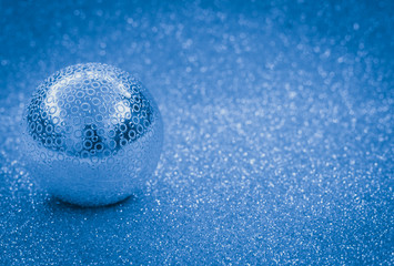 grey new year toy on shiny silver background creative flat lay with copy space