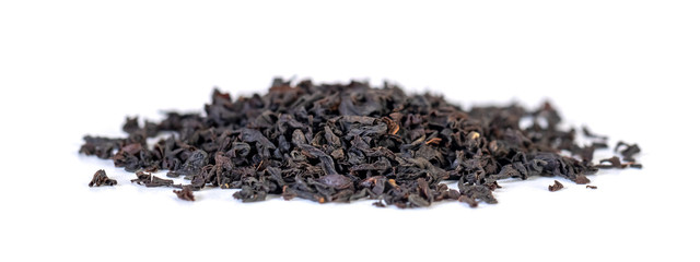 A pile of dried black tea leaves on a white background.