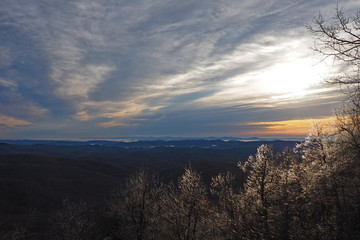 Colorful sunrise over layered mountains after ice storm in Blowing Rock, North Carolina.