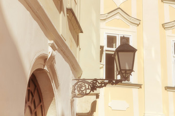 Fototapeta na wymiar View of old lantern on the street of Bratislava, Slovakia. Old buildings as background. Vintage filter
