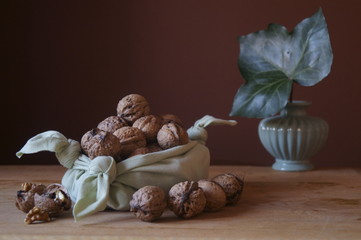 Rustic arrangement with walnuts on a wooden table