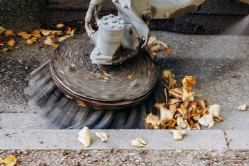 Sweeping machine removes leaves on the street
