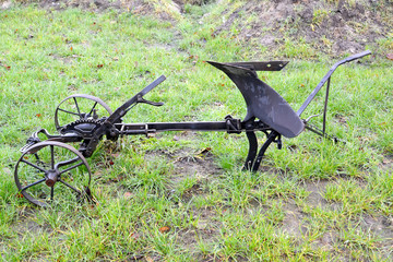 Horse plough lies on grass