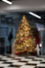 Blured christmas tree in the shopping mall.Defocused background.
