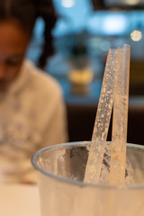 used plastic straws and cup on restaurant table 
