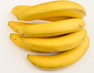 Bunch of ripe yellow bananas on a white background. Close up.