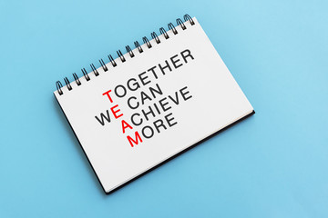 Inspirational quotes text on note pad - Together we can achieve more. Team and leadership concept