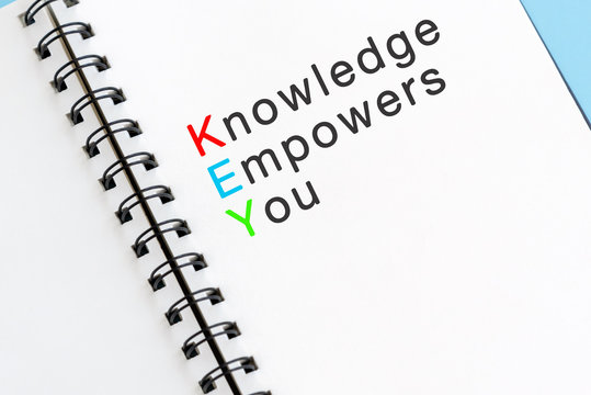 KEY acronym - Knowledge empowers you Text on note pad.
