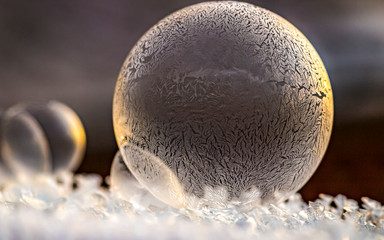 Close-up of a frozen soap bubble in the back light