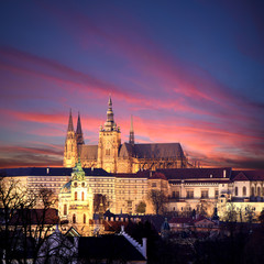 Naklejka premium panoramic view To Hradschin Castle, St. Vitus Cathedral And Charles Bridge In Prague, Czech Republic during sunset with dramatic sky