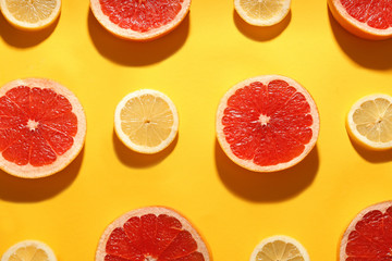 Flat lay composition with tasty ripe grapefruit slices on yellow background