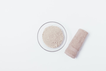 Dry clay powder in bowl next to cotton towel