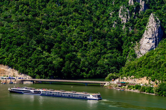 Cruise ship passing by rock sculpture of Decebalus in Danube gorge