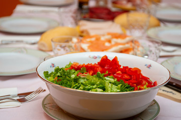 salad bowl in the foreground on a laid table