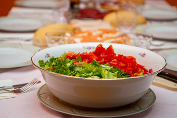 salad bowl in the foreground on a laid table