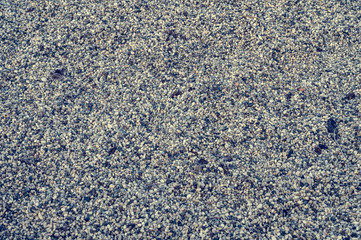 Texture pattern of many small gray stones.