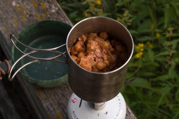 Bean porridge in a bowl. Food in nature. Warming up food in nature.