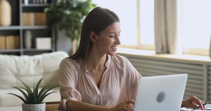 Woman online teacher wear earphone video conference calling on laptop