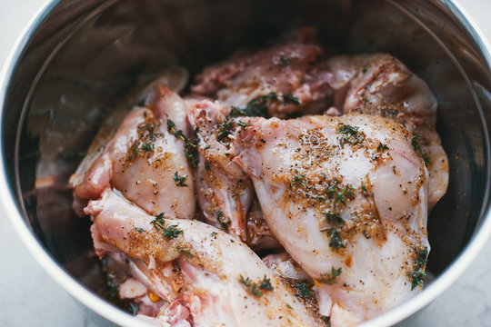 Raw rabbit meat in thyme marinade